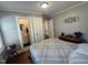Comfortable bedroom features charming decor, adjacent powder room, and calming ambiance at 306 W Canary St, Dunn, NC 28334