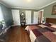 Spacious bedroom with green walls, hardwood floors, and natural light at 306 W Canary St, Dunn, NC 28334