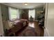 Bedroom boasts green walls, natural light, and hardwood floors at 306 W Canary St, Dunn, NC 28334