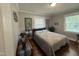 Bedroom with large windows, hardwood floors, and neutral decor, offering serene comfort at 306 W Canary St, Dunn, NC 28334