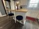 Kitchen island with bar seating and hardwood countertop, set in kitchen with stainless appliances at 306 W Canary St, Dunn, NC 28334