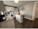 Cozy kitchen featuring white cabinets, stainless appliances, and an island with a butcher block countertop at 306 W Canary St, Dunn, NC 28334