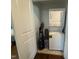 This laundry room features a stacked washer and dryer set, and storage space at 306 W Canary St, Dunn, NC 28334