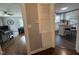 View of the living room and kitchen with hardwood floors and updated appliances at 306 W Canary St, Dunn, NC 28334