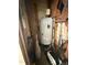 A storage area or shed featuring a water heater, vacuum cleaner, and various gardening tools at 306 W Canary St, Dunn, NC 28334