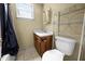 Cozy bathroom with vanity, toilet, and shelving unit for storage at 312 W Front St, Oxford, NC 27565