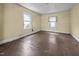 Bright bedroom with hardwood floors, two windows bringing in natural light, and neutral colored walls at 312 W Front St, Oxford, NC 27565