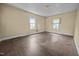 A well-lit bedroom featuring hardwood floors and natural light from two windows at 312 W Front St, Oxford, NC 27565