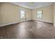 Empty bedroom featuring hardwood floors and two windows providing natural light and a view of the outdoors at 312 W Front St, Oxford, NC 27565