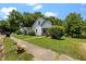 Side view of a charming home with a green lawn and sidewalk leading to the entrance at 312 W Front St, Oxford, NC 27565