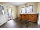 Kitchen features wood cabinets, a sink, and an open doorway to another room at 312 W Front St, Oxford, NC 27565