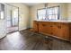 Functional kitchen area with wooden cabinetry, ample counter space, and an adjacent entryway with natural light at 312 W Front St, Oxford, NC 27565