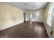 Living room featuring hardwood floors, a ceiling light, and multiple doorways at 312 W Front St, Oxford, NC 27565