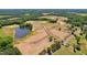 Aerial view of new construction community featuring expansive lots, a pond, and surrounding trees at 331 Bunker Hill Place, Angier, NC 27501