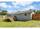 Backyard view of the home with a deck and well-maintained lawn at 4021 Chaucer Dr, Durham, NC 27705