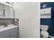 Half bath features modern vanity, new fixtures, and wood paneled accent wall at 4021 Chaucer Dr, Durham, NC 27705