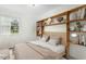 Bright bedroom with light wood floors and built-in shelving at 4021 Chaucer Dr, Durham, NC 27705