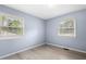 Cozy bedroom featuring natural light, wood floors, and neutral walls at 4021 Chaucer Dr, Durham, NC 27705