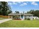 A beautifully landscaped home with a well-maintained lawn and a side carport at 4021 Chaucer Dr, Durham, NC 27705
