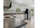 Bright, updated kitchen with white cabinets, stainless steel dishwasher, and sliding doors to backyard at 4021 Chaucer Dr, Durham, NC 27705