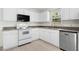 Bright kitchen featuring white cabinets, stainless steel dishwasher, and updated countertops at 4021 Chaucer Dr, Durham, NC 27705