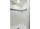 Modern shower with white tile, mosaic accent stripe, rainfall shower head, and glass shelf at 4021 Chaucer Dr, Durham, NC 27705