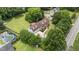 Aerial view of a home with a pool, yard, and large driveway highlights the property's features and surroundings at 4259 Old Faison Rd, Knightdale, NC 27545