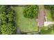 Aerial view of a large, grassy yard with a home and mature trees showcases the property's size and privacy at 4259 Old Faison Rd, Knightdale, NC 27545