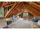 Attic storage space with exposed beams, some clutter, and a window for natural light at 4259 Old Faison Rd, Knightdale, NC 27545