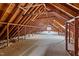 Large unfinished attic space with exposed wooden beams and insulation at 4259 Old Faison Rd, Knightdale, NC 27545