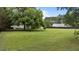 Expansive backyard featuring lush green grass and a mature shade tree provides ample space for outdoor activities at 4259 Old Faison Rd, Knightdale, NC 27545