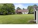 A large yard with a deck and mature trees surrounds the home, offering plenty of room for outdoor activities and enjoyment at 4259 Old Faison Rd, Knightdale, NC 27545