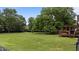Spacious backyard showcasing a level lawn and a covered deck offers a perfect setting for outdoor gatherings and relaxation at 4259 Old Faison Rd, Knightdale, NC 27545