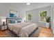 Well-lit bedroom with large windows, a plush bed, and stylish decor at 4259 Old Faison Rd, Knightdale, NC 27545