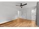Spacious bedroom with hardwood floors, ceiling fan, and access to bathroom with glass-enclosed shower at 4259 Old Faison Rd, Knightdale, NC 27545