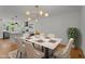 Open concept dining room features a modern chandelier, with an adjoining kitchen and a marble-topped table at 4259 Old Faison Rd, Knightdale, NC 27545
