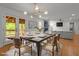 Bright dining room with modern lighting, white walls, and a view of the outdoor deck at 4259 Old Faison Rd, Knightdale, NC 27545
