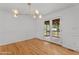 Bright dining room with modern light fixture and glass doors to the outdoor deck at 4259 Old Faison Rd, Knightdale, NC 27545