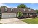 Charming two-story home featuring a two car garage, brown roof, white siding, and a covered front porch at 4259 Old Faison Rd, Knightdale, NC 27545