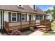 Inviting front porch with a brown wood deck, black shutters, and decorative landscaping at 4259 Old Faison Rd, Knightdale, NC 27545