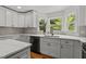 Modern kitchen with white cabinets, marble countertops, and stainless steel appliances at 4259 Old Faison Rd, Knightdale, NC 27545