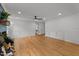 Bright, open living room featuring wood floors, white trim, and a decorative brick fireplace at 4259 Old Faison Rd, Knightdale, NC 27545