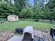 Landscaped backyard with a garden shed and a rustic wooden fence at 4601 Orange Grove Rd, Hillsborough, NC 27278