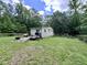 This backyard setting has a wooden deck, complete with outdoor cooking essentials at 4601 Orange Grove Rd, Hillsborough, NC 27278