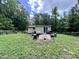 This backyard setting has a wooden deck, complete with outdoor cooking essentials at 4601 Orange Grove Rd, Hillsborough, NC 27278