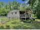 Charming single-story home featuring a covered front porch and a quaint fenced yard at 4601 Orange Grove Rd, Hillsborough, NC 27278