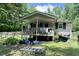 Charming single-story home featuring a covered front porch and a quaint fenced yard at 4601 Orange Grove Rd, Hillsborough, NC 27278