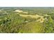 An aerial view of a home site surrounded by lush green trees at 4964 Stafford Mill Rd, Liberty, NC 27298
