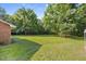 Expansive backyard with mature trees surrounding the home at 4964 Stafford Mill Rd, Liberty, NC 27298