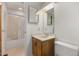 Bathroom with cream walls, a standard toilet, a vanity, and a bathtub with glass doors at 4964 Stafford Mill Rd, Liberty, NC 27298